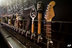 In this July 21, 2017 photo, a craft beer wall of taps is seen at the RULE Taproom pub in Moscow, Russia.