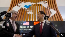 U.S. Secretary of Energy Ernest Moniz, left, and Chairman Xu Dazhe of the Chinese Atomic Energy Authority shakes hands at the Nuclear Security Center of Excellence in Beijing, China, March 18, 2016. 