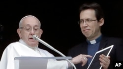 Pope Francis points at a tablet as he unveils his own user profile in Click To Pray, the official app of the Pope's Worldwide Prayer Network, at St. Peter's Square, the Vatican, on Sunday, Jan. 20, 2019. (AP Photo/Andrew Medichini)