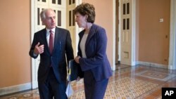 Senate Foreign Relations Committee Chairman Sen. Bob Corker, R-Tenn., Sen. Susan Collins, R-Maine, a member of the Intelligence Committee, confer outside the Senate chamber on Capitol Hill in Washington, as GOP leaders in Congress are calling for a pause in Syrian refugees coming to the U.S. in the wake of the Paris attacks.