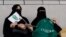 FILE - Saudi women watch the soccer match between Al-Ahli against Al-Batin at the King Abdullah Sports City in Jeddah, Saudi Arabia, Jan. 12, 2018.
