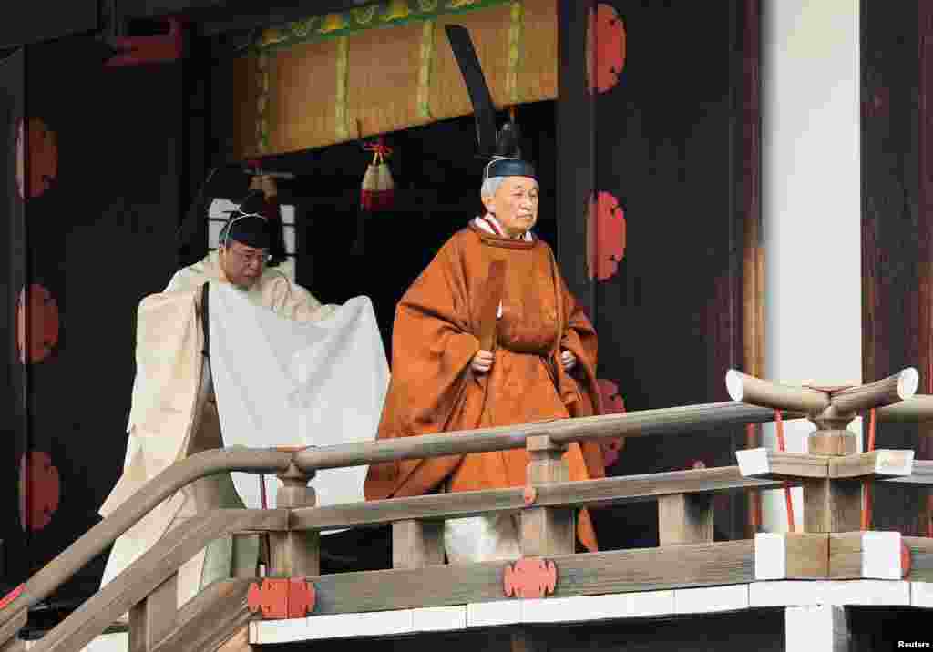 Japan&#39;s Emperor Akihito walks for a ritual called Taiirei-Tojitsu-Kashikodokoro-Omae-no-gi, a ceremony for the Emperor to report the conduct of the abdication ceremony, at the Imperial Palace in Tokyo, in this photo released by Kyodo.