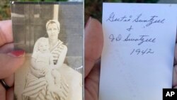 This photo combo shows Katie Posten holding the front and back of a photograph she found stuck to her car's windshield Dec. 11, 2021, in New Albany, Indiana. The photo is from a tornado-damaged home in Kentucky that landed more than 200 kilometers away in