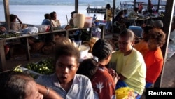 Sekelompok perempuan Papua Barat bersantai di pinggiran Danau Sentani, 2004.(Foto:Dok/REUTERS/Beawiharta)