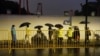 Police officers keep watch near barricades set up along Julu Road where people in Halloween costumes gathered the year before, in Shanghai, China, on Oct. 26, 2024.