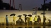 Police officers keep watch near barricades set up along Julu Road where people in Halloween costumes gathered the year before, in Shanghai, China, October 26, 2024. 