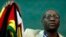 FILE - Zimbabwean Pastor Evan Mawarire holds his country's flag before addressing supporters at the University of the Witwatersrand in Johannesburg, South Africa, July 28, 2016.