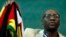 FILE - Zimbabwean Pastor Evan Mawarire holds his country's flag before addressing supporters at the University of the Witwatersrand in Johannesburg, South Africa, July 28, 2016.
