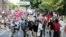 White nationalist demonstrators walk through town after their rally was declared illegal near Lee Park in Charlottesville, Va., Aug. 12, 2017. 