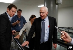 FILE - Sen. John McCain talks to reporters on Capitol Hill in Washington, Oct. 18, 2017.