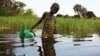 FILE - A girl prepares to collect water in a plastic can in South Sudan, Aug. 19, 2018.