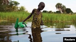 FILE - A girl prepares to collect water in a plastic can in South Sudan, Aug. 19, 2018.