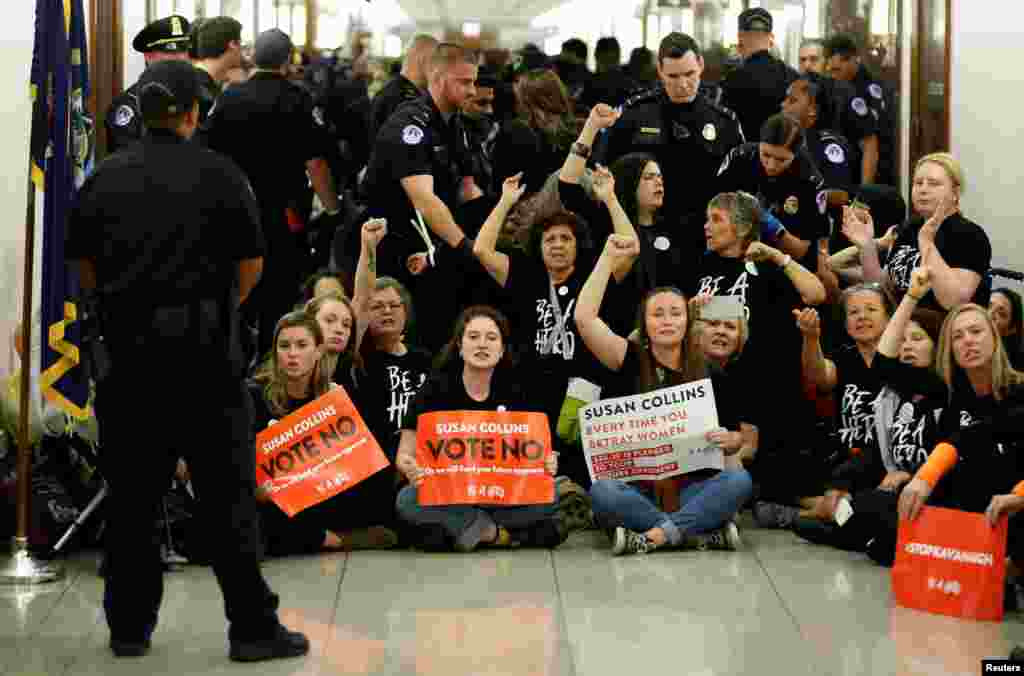 Demonstrators shout before being arrested as they protest against U.S. Supreme Court nominee Brett Kavanaugh in front of the office of Senator Susan Collins (R-ME) on Capitol Hill in Washington.