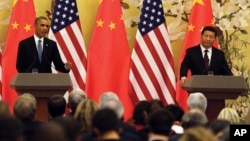 In this file photo, U.S. President Barack Obama, left, speaks next to Chinese President Xi Jinping during their joint press conference at the Great Hall of the People in Beijing on Nov. 12, 2014. (AP Photo/Andy Wong)