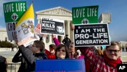 FILE - Anti-abortion activists protest outside of the U.S. Supreme Court, during the March for Life in Washington, Jan. 18, 2019.