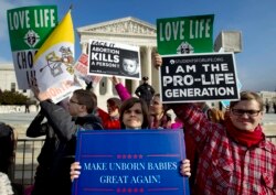 FILE - In this Jan. 18, 2019, file photo, anti-abortion activists protest outside of the U.S. Supreme Court, during the March for Life in Washington.