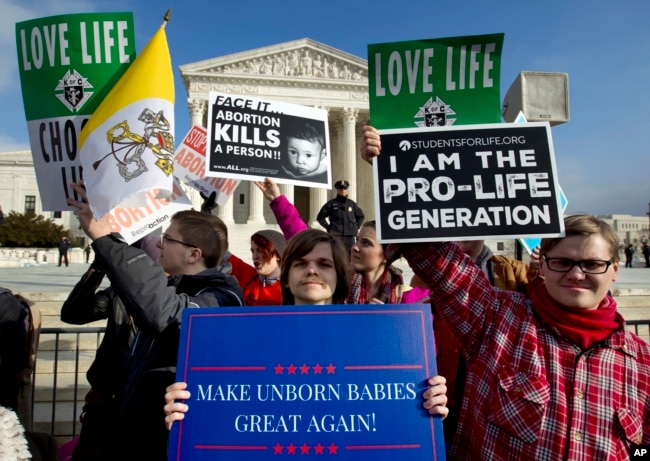 FILE - Anti-abortion activists protest outside of the U.S. Supreme Court, during the March for Life in Washington, Jan. 18, 2019.