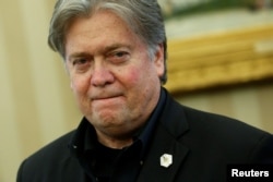 FILE - White House senior advisor Steve Bannon attends as U.S. President Donald Trump signs executive orders in the Oval Office at the White House in Washington, Jan. 28, 2017.