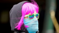 FILE PHOTO: FILE PHOTO: A person wears a scarf as a protective face mask in Melbourne, the first city in Australia to enforce mask-wearing to curb a resurgence of COVID-19