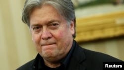 FILE - White House senior advisor Steve Bannon attends as U.S. President Donald Trump signs executive orders in the Oval Office at the White House in Washington, U.S. Jan. 28, 2017. 