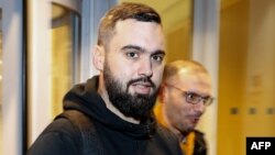 FILE - Eric Drouet, a leader of the "Yellow vests" (Gilets jaunes) movement, next to his lawyer Kheops Lara (R) as he leaves Paris' courthouse after being detained by the police during a yellow vests demonstration in Paris, Dec. 23, 2018.