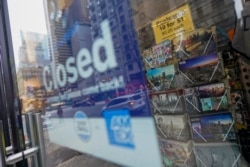 New York City postcards are seen on display for sale at a closed gift shop, Nov. 12, 2020, in New York's Times Square.