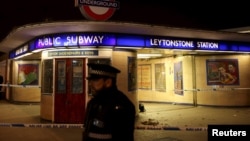 Police officers investigate a crime scene at Leytonstone Underground station in east London, Britain, Dec. 6, 2015.