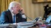 FILE - President Donald Trump speaks on the phone with Russian President Vladimir Putin, Jan. 28, 2017, in the Oval Office at the White House in Washington. 