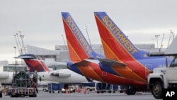 FILE - Southwest Airlines are seen parked at a gate in Tacoma International Airport in Seattle.