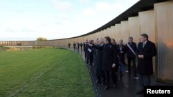 French President Emmanuel Macron visits the "Ring of Memory" international World War I memorial, at the Notre Dame de Lorette French War Cemetery near Arras, France, Nov. 8, 2018.