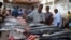 FILE - Somali traders prepare sword fish at the Hamarweyne market in southern Mogadishu, Aug. 16, 2010. 
