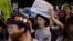 Members of Students Emergency Action for Liberal Democracy shout slogans during a protest outside parliament in Tokyo, Aug. 21, 2015.