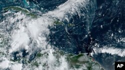 This image provided by the National Oceanic and Atmospheric Administration shows a cluster of storms located south of the Cayman Islands which are expected to strengthen in upcoming days, Sept. 23, 2024.