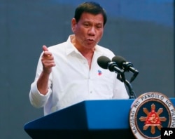 FILE - Philippine President Rodrigo Duterte gestures during his address to a Filipino business sector in suburban Pasay city south of Manila, Philippines, Oct. 13, 2016.