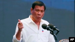 FILE - Philippine President Rodrigo Duterte gestures during his address to a Filipino business sector in suburban Pasay city south of Manila, Philippines.