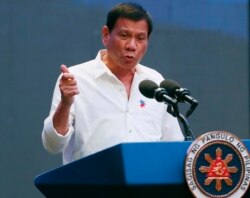 FILE - Philippine President Rodrigo Duterte gestures during his address to a Filipino business sector in suburban Pasay city south of Manila, Philippines, Oct. 13, 2016.