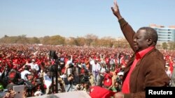 Prime Minister Morgan Tsvangirai, the leader of Zimbabwe's opposition party Movement For Democratic Change (MDC), greets supporters at a rally in Harare, July 29, 2013.