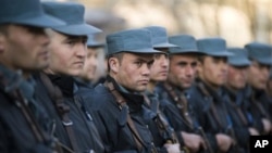 In this Feb. 20, 2011 photo provided by NATO Training Mission-Afghanistan, trainees at the Afghan National Police Academy stand in formation during a visit to the academy by a U.S. Congressional delegation in Kabul, Afghanistan.