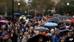 People stand outside the Soldiers & Sailors Memorial Hall & Museum due to over-capacity at a community gathering inside, Oct. 28, 2018, in Pittsburgh, in the aftermath of the deadly shooting at the Tree of Life Synagogue a day earlier.