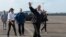 President Donald Trump and first lady Melania Trump walk to board Air Force One at Chennault International Airport in Lake Charles, La., following a visit with those helping with the impacted of Hurricane Harvey, Saturday, Sept. 2, 2017. 