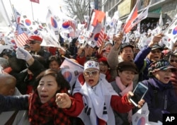 Supporters of South Korean President Park Geun-hye shout slogans during a rally opposing her impeachment near Constitutional Court in Seoul, South Korea, March 10, 2017.