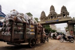 រូបឯកសារ៖ ពលករ​ខ្មែរ​ដឹក​ឥវ៉ាន់​របស់​ពួកគេ​ចេញ​ពី​ប្រទេស​ថៃ នៅ​ឯ​ច្រកព្រំដែន​អន្តរជាតិ​កម្ពុជា​-ថៃ នៅ​ក្រុង​ប៉ោយប៉ែត ​ថ្ងៃទី​១៨ ខែមិថុនា ឆ្នាំ​២០១៤។ (AP Photo/Heng Sinith)