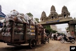 រូបឯកសារ៖ ពលករ​ខ្មែរ​ដឹក​ឥវ៉ាន់​របស់​ពួកគេ​ចេញ​ពី​ប្រទេស​ថៃ នៅ​ឯ​ច្រកព្រំដែន​អន្តរជាតិ​កម្ពុជា​-ថៃ នៅ​ក្រុង​ប៉ោយប៉ែត ​ថ្ងៃទី​១៨ ខែមិថុនា ឆ្នាំ​២០១៤។ (AP Photo/Heng Sinith)