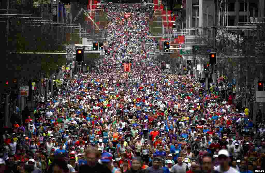 Runners start the 44th annual City2Surf fun run down Sydney&#39;s William Street, Australia. Around 80,000 people participated in the run, which covers a distance of 14km (8.7 miles) from the city to Bondi Beach.