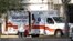 A paramedic dressed in personal protective equipment exits an ambulance at St. Petersburg General Hospital in Florida