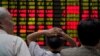 Investors look at an electronic board showing stock information at a brokerage house in Shanghai, China, June 20, 2018. 