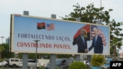 A poster showing a picture of Angola President João Lourenço shaking hands with US President Joe Biden is seen in Luanda on Dec. 2, 2024 ahead of the arrival of the American President in Angola. 