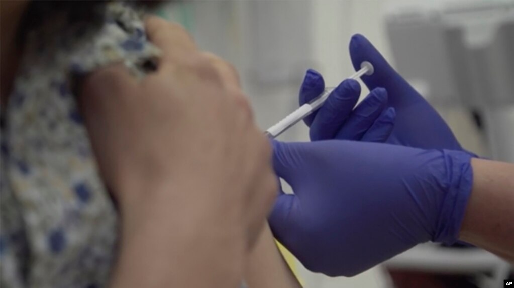 Screen grab taken from video issued by Britain's Oxford University, showing a person being injected as part of the first human trials in the UK to test a potential coronavirus vaccine, untaken by Oxford University in England, Thursday April 23, 2020…