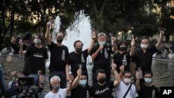 Activists chant slogans during a gathering to mourn those killed in the 1989 Tiananmen crackdown at Victoria Park in Causeway Bay, Hong Kong, June 4, 2020.