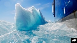 Broken sea ice emerges from under the hull of the Finnish icebreaker MSV Nordica as it sails through the Victoria Strait while traversing the Arctic's Northwest Passage, July 21, 2017.